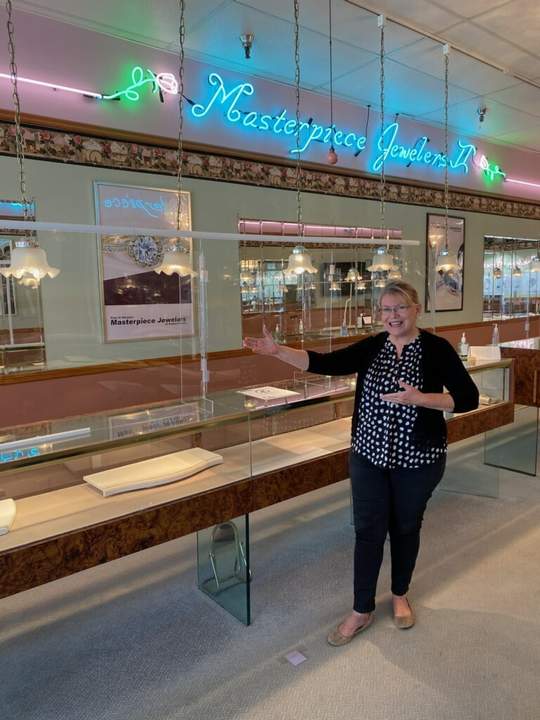 Tracy shows off the new Lucite safety barriers at your family jewelry store, Masterpiece Jewelers.